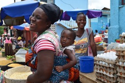 Ghanaian woman with baby strapped to her back