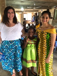 Interns (female) with young Ghanaian girl
